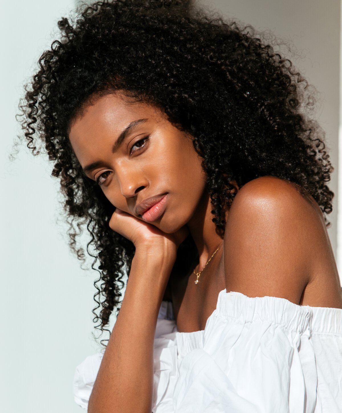 Los Angeles rhinoplasty model resting chin on hand