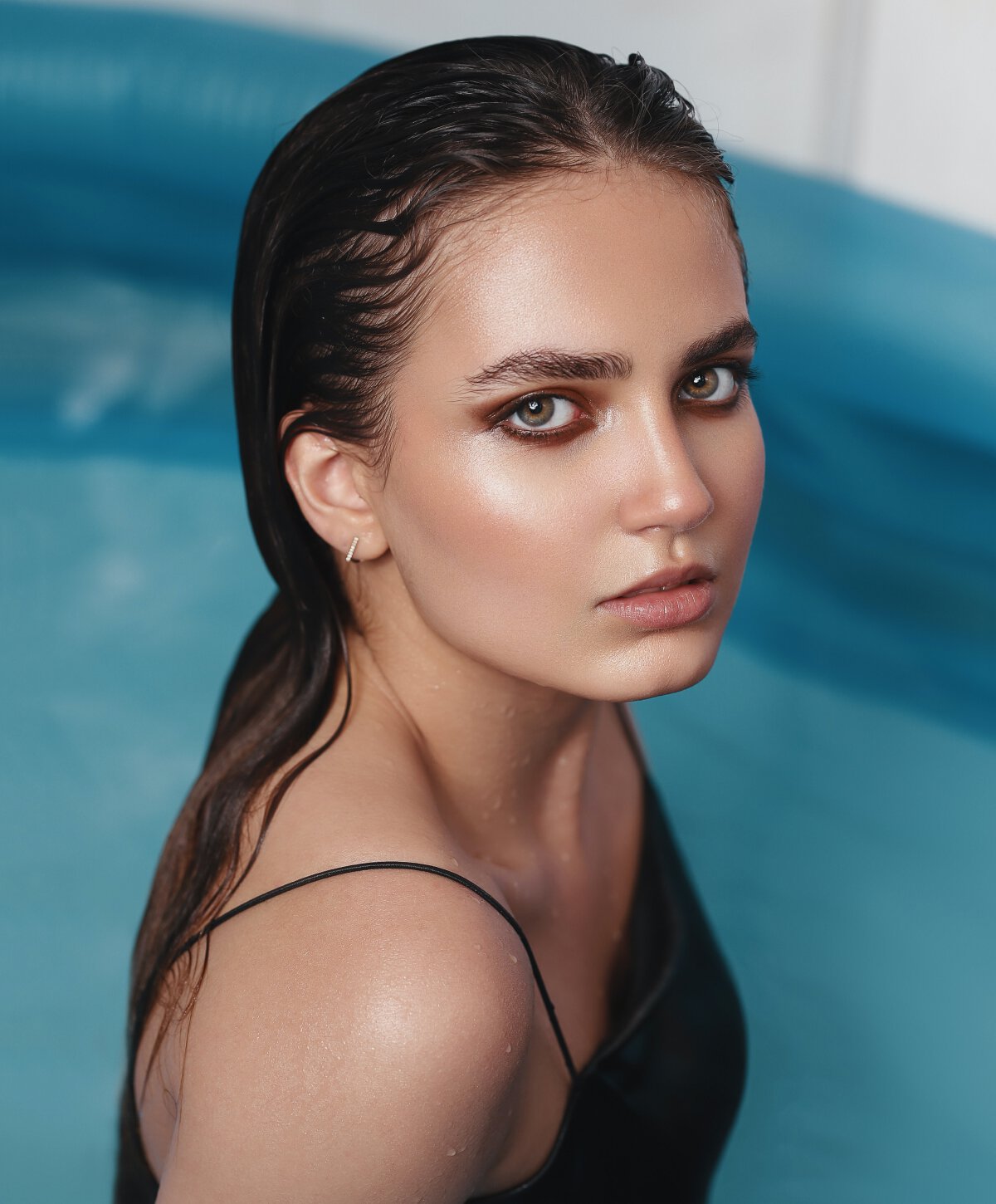 Los Angeles kybella patient model with brown hair in a pool