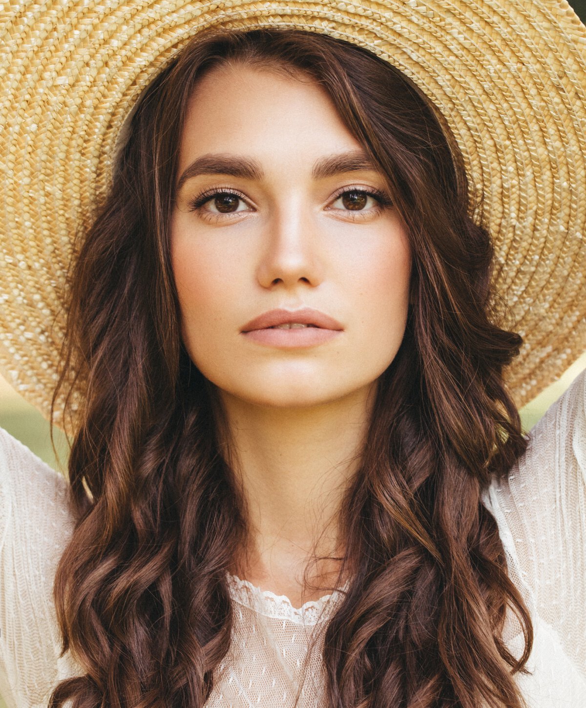 Los Angeles laser hair removal patient model wearing a wide-brimmed sun hat