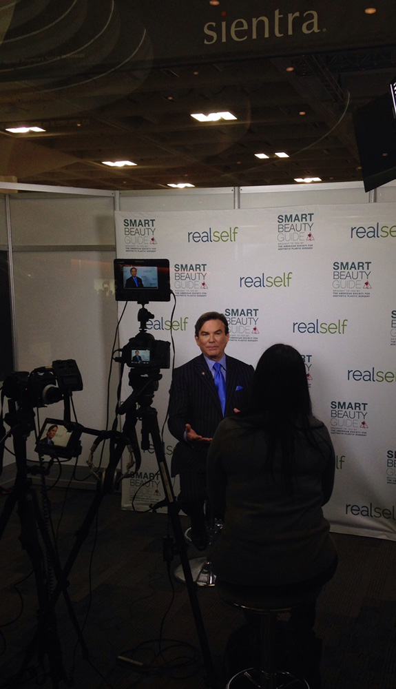 los angeles plastic surgeon dr grant stevens giving interview wide angle
