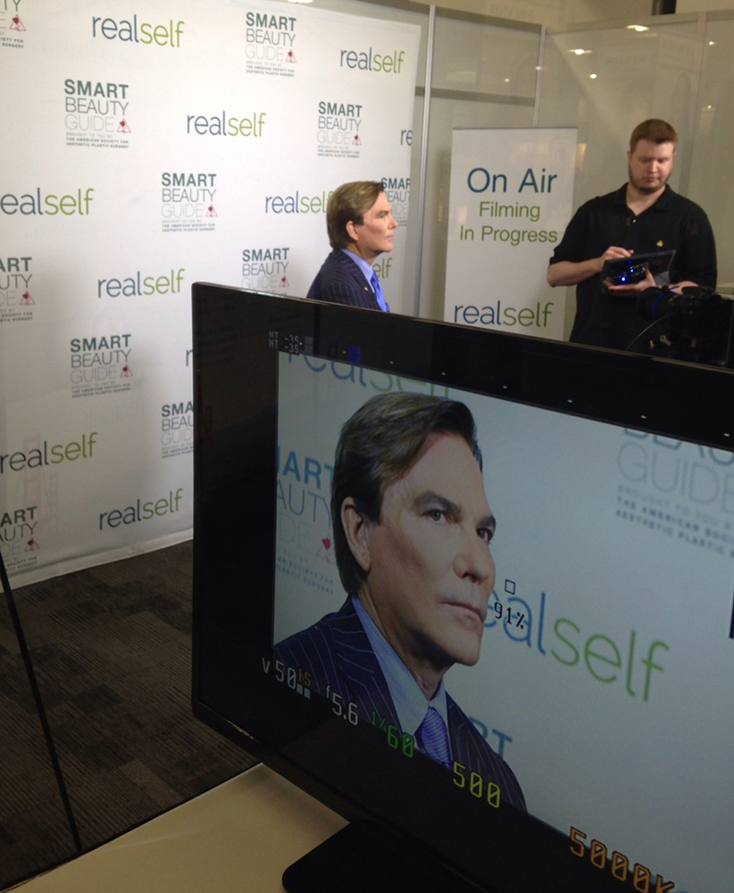 los angeles plastic surgeon dr grant stevens giving interview computer screen angle